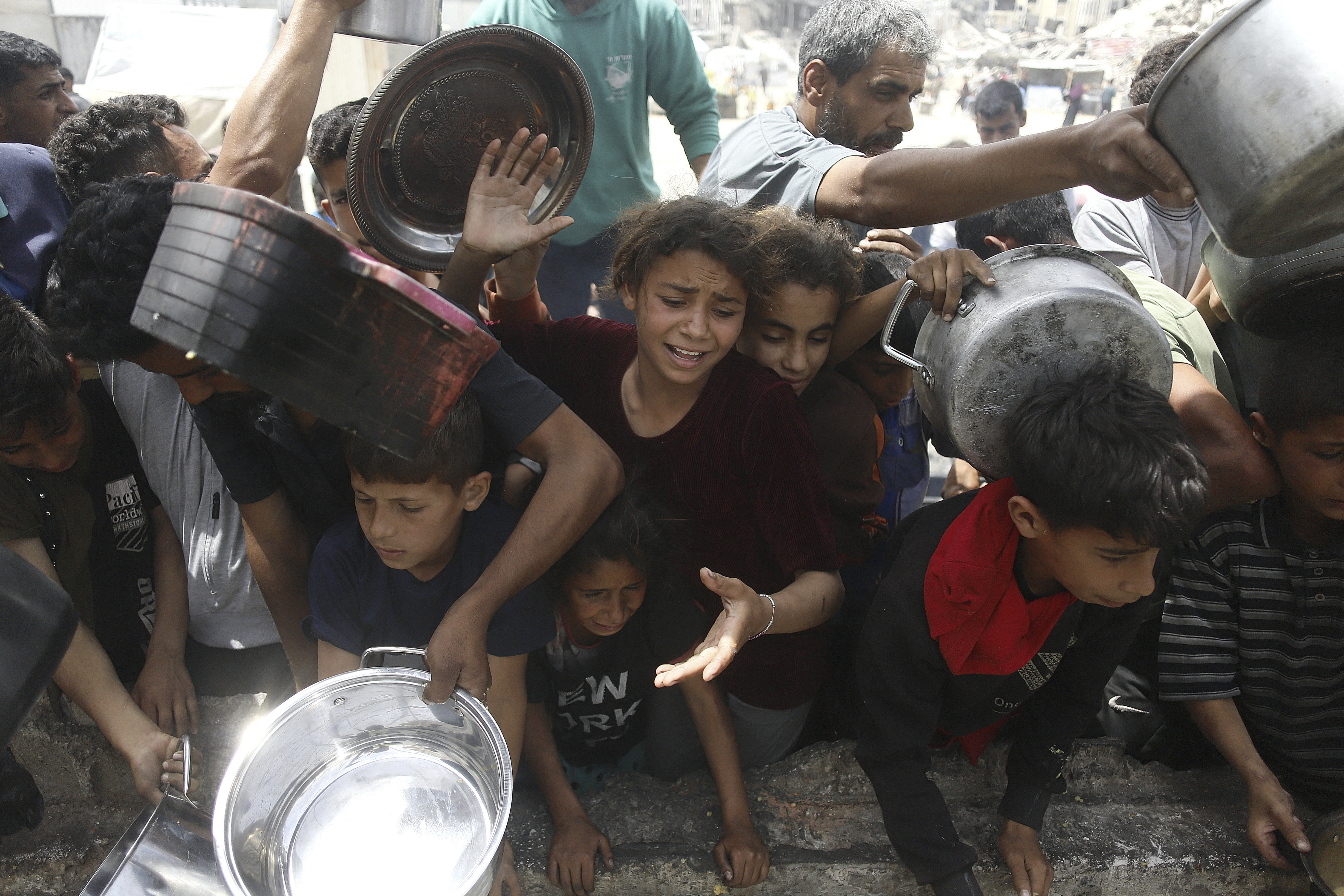Palestinians line up for a meal in BeitLahia, Gaza Strip, Palestine on April 24, 2025.