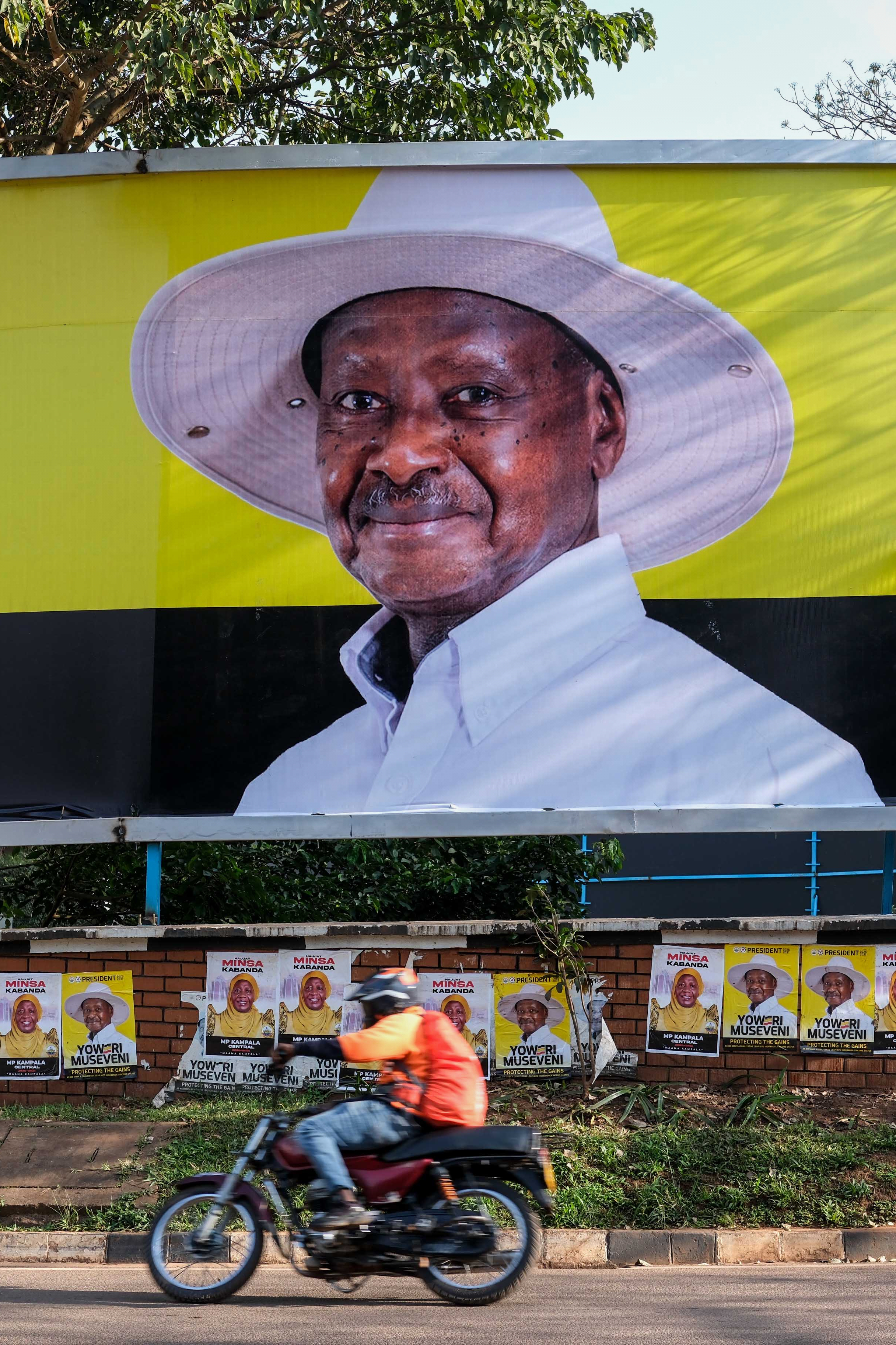 A motorist passes President Yoweri Museveni's campaign billboard in Kampala, Uganda, Wednesday, Jan. 7, 2026. (AP Photo/Hajarah Nalwadda)