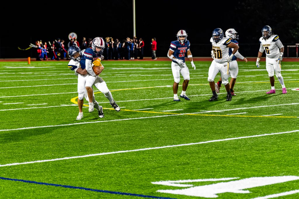 Blue Jay junior Devon Crawford brings down Kennedy in the backfield for a sack, stalling the Patriot drive.