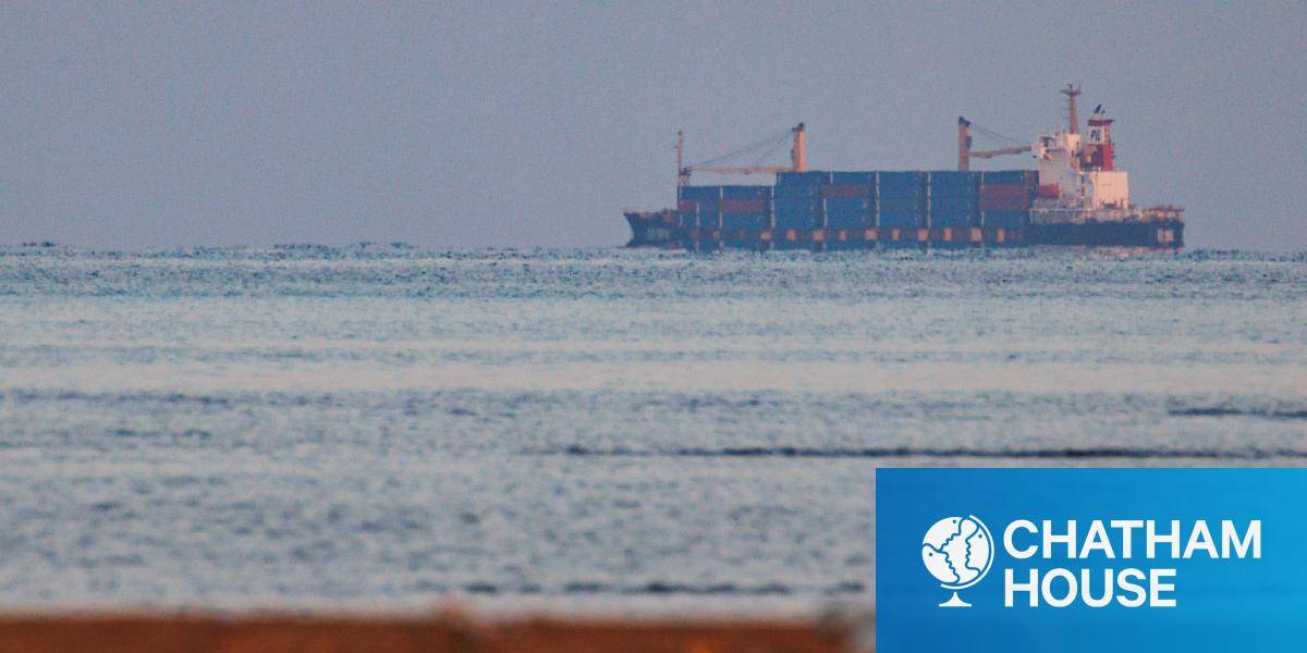 Pictured from the shore, a container ship approaches the Bab-al-Mandab strait on 18 January 2024. 