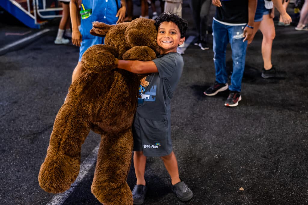 This young man is all smiles after winning a stuffed moose.