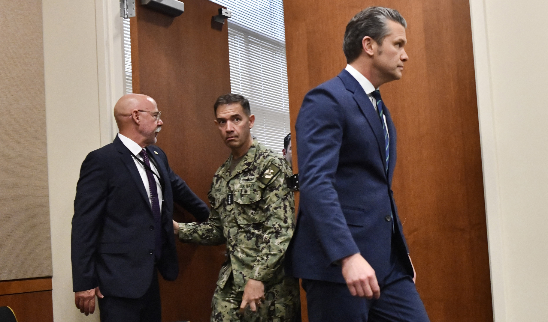 Admiral Charles Bradford "Brad" Cooper II, Commander of US Central Command (C) arrives for a joint press conference with US Secretary of Defense Pete Hegseth (R), at US Central Command (CENTCOM) headquarters at MacDill Air Force Base in Tampa, Florida, on March 5, 2026. (Photo by Octavio JONES / AFP via Getty Images)