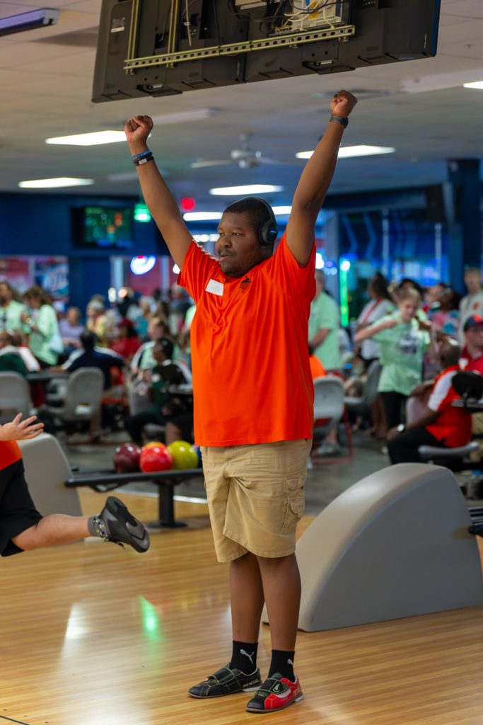 A member of the Wilmington Wizards celebrates a good bowl with his arms outstretched.