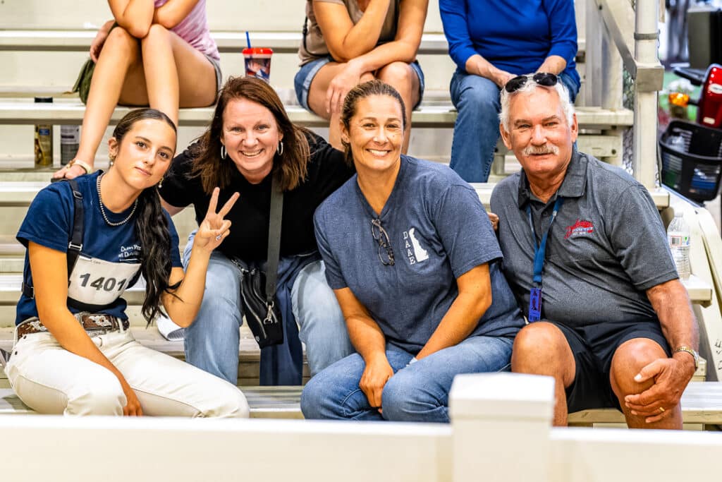Members of the Nacrelli family pose for a quick picture from the stands of the Open Dairy Cattle Show.