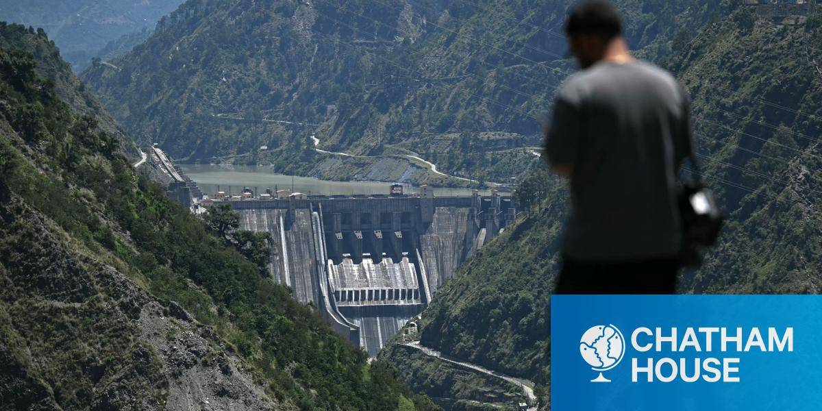 A journalist standing against the backdrop of the Baglihar Dam, on the river Chenab in the Ramban district of Jammu and Kashmir. 
