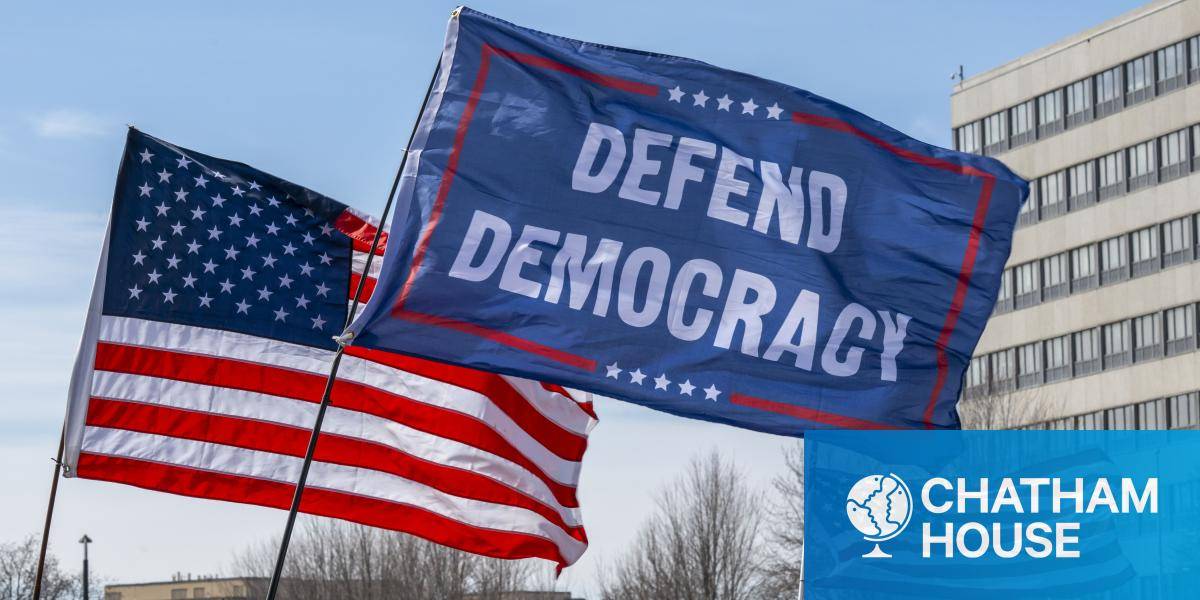 US flags at a 'No Kings' rally in Minnesota, including a flag saying 'defend democracy'
