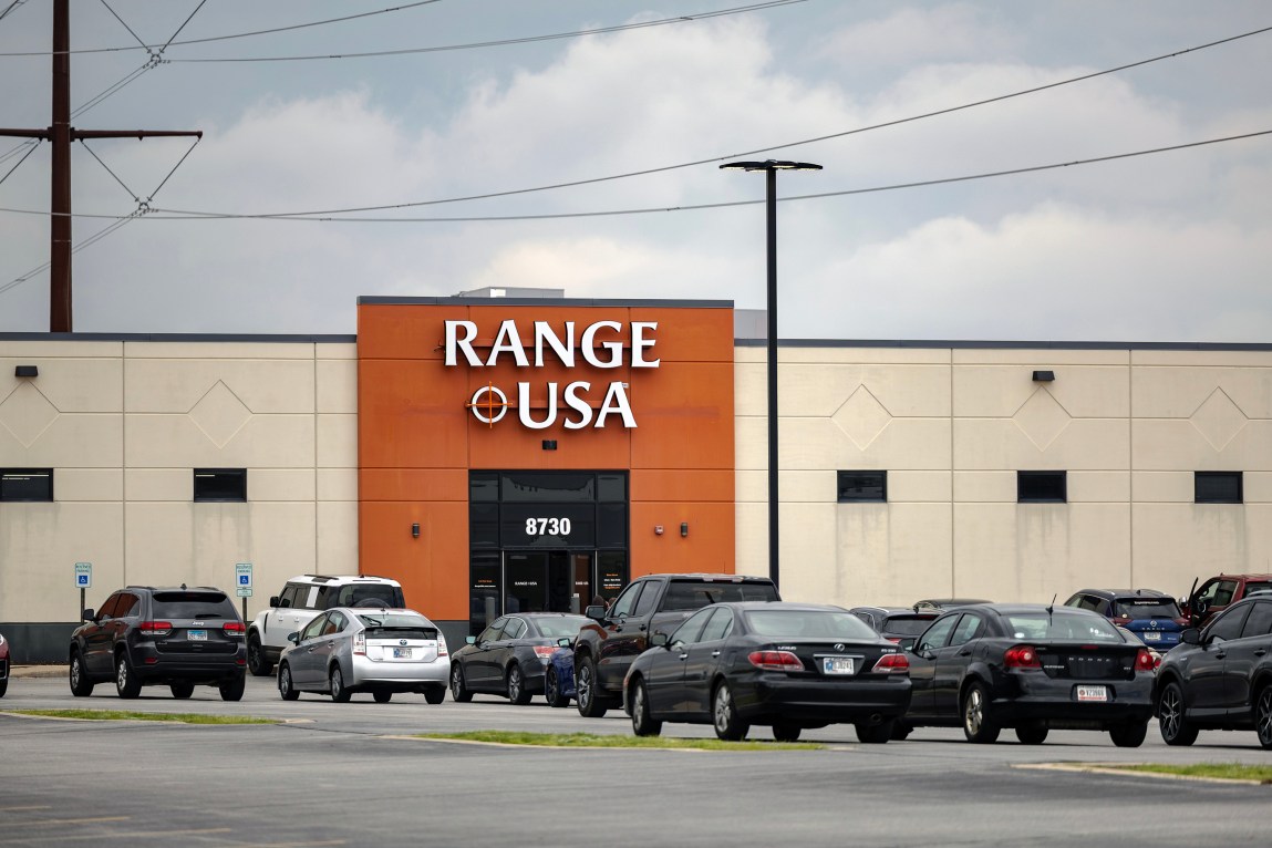 The exterior of a Range USA facility featuring an orange-and-cream-colored building with a large parking lot in front.