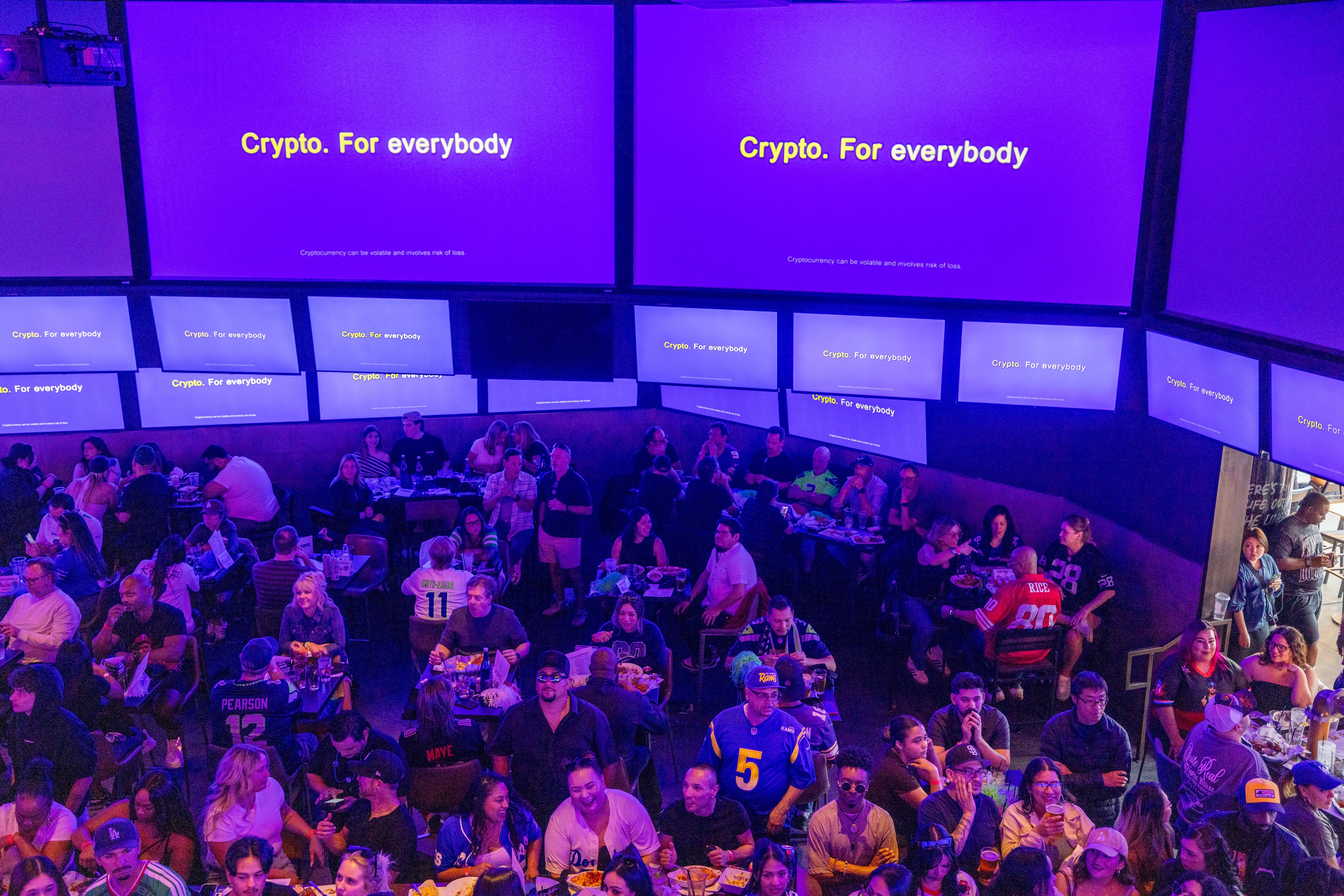 A commercial for crypto during the Super Bowl LX broadcast on a television at a bar in Los Angeles California, US, on Sunday, Feb. 8, 2026. Super Bowl viewers can expect to see more ads from the technology, pharmaceutical and wellness industries as they watch the Seattle Seahawks take on the New England Patriots during the broadcast on NBC. Photographer: Jill Connelly/Bloomberg via Getty Images