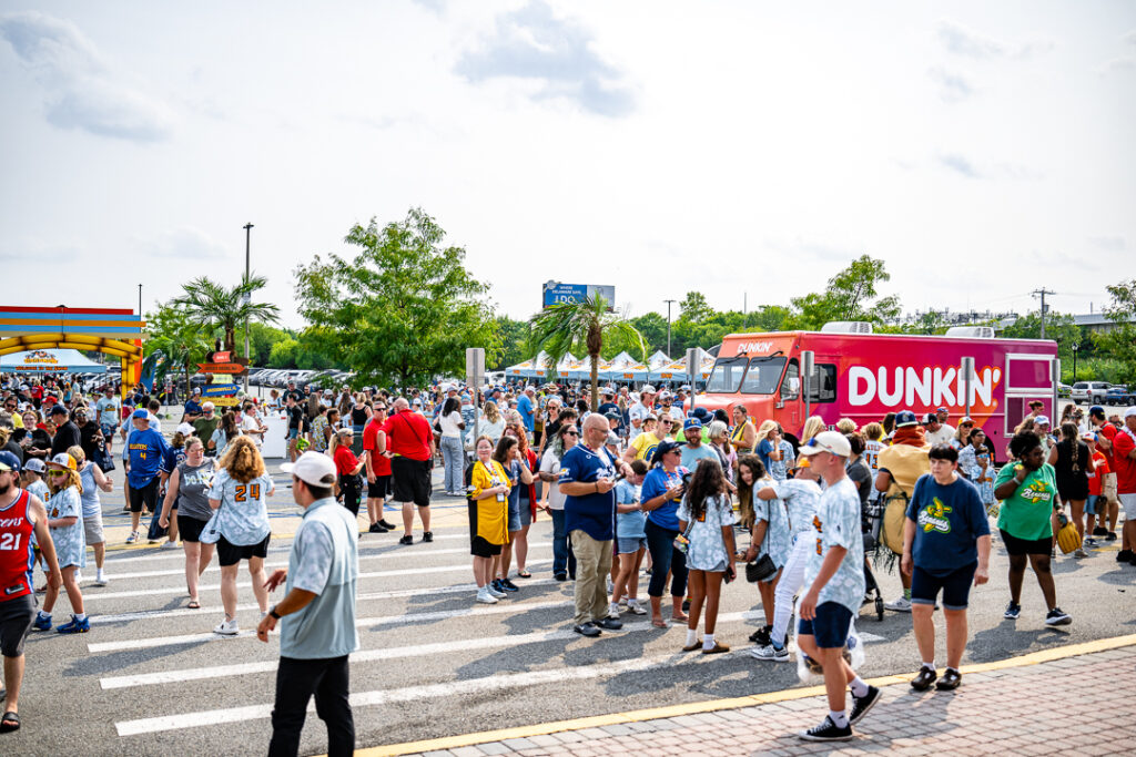 Fans enter the plaza before the gates to the stadium officially open for the game.