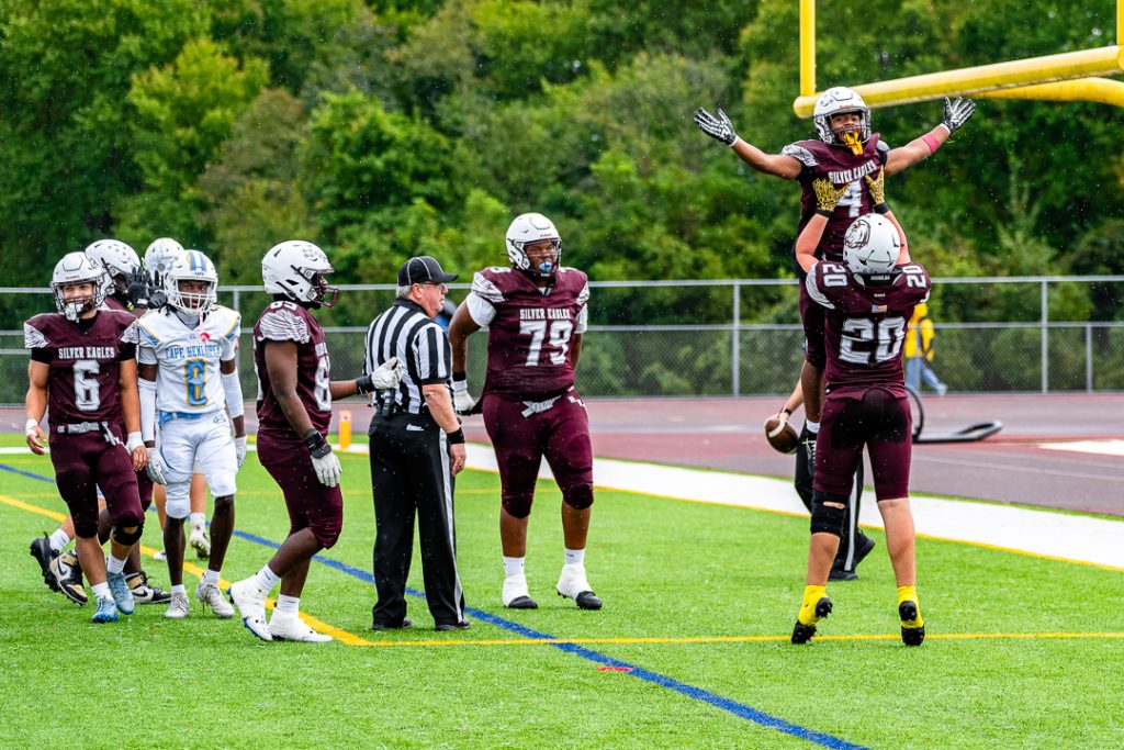 Sabur is lifted into the air by senior Braden Collins after scoring his second touchdown of the first quarter.