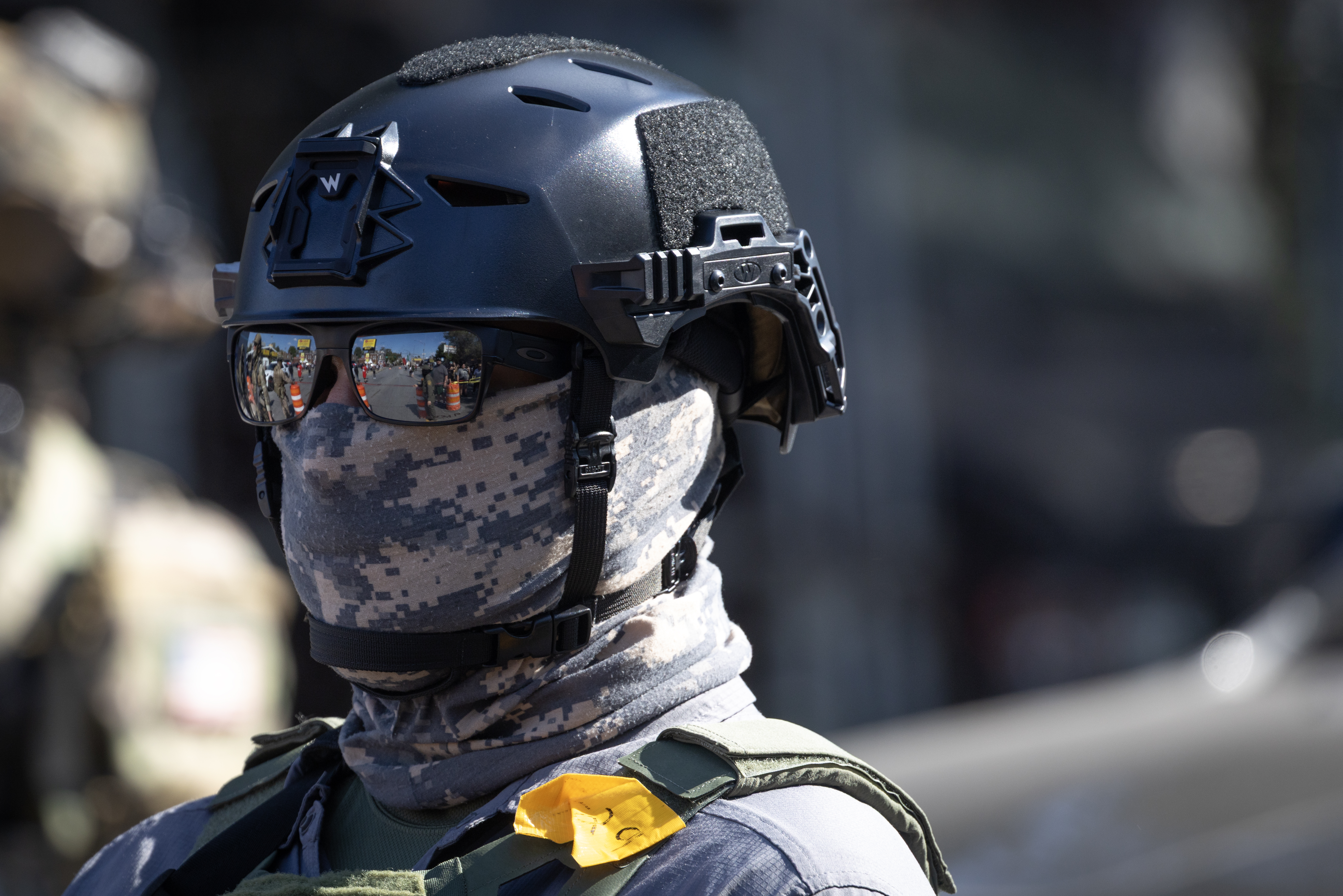 CHICAGO, ILLINOIS - OCTOBER 04: Federal law enforcement agents stand guard as they are confronted by community members and activists for reportedly shooting a woman in the Brighton Park neighborhood on October 04, 2025 in Broadview, Illinois. Residents of the city have become increasingly concerned as Operation Midway Blitz continues in the Chicago area, an operation designed to apprehend and deport undocumented immigrants living in the area.  (Photo by Scott Olson/Getty Images)