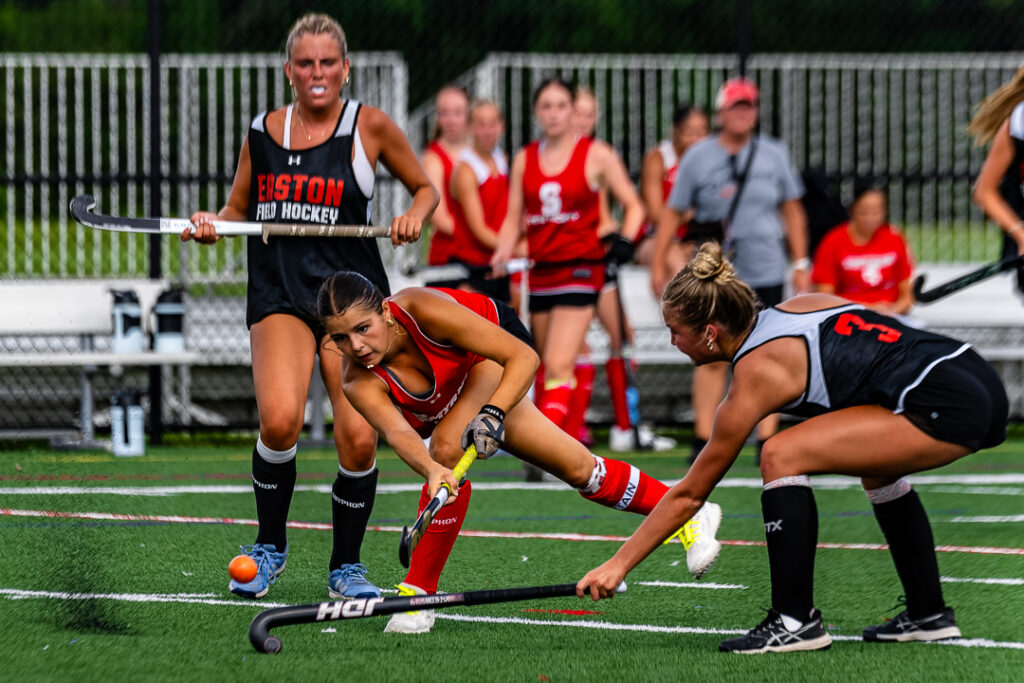 A Smyrna player shoots a shot toward the cage while avoiding the the defenders in her path.