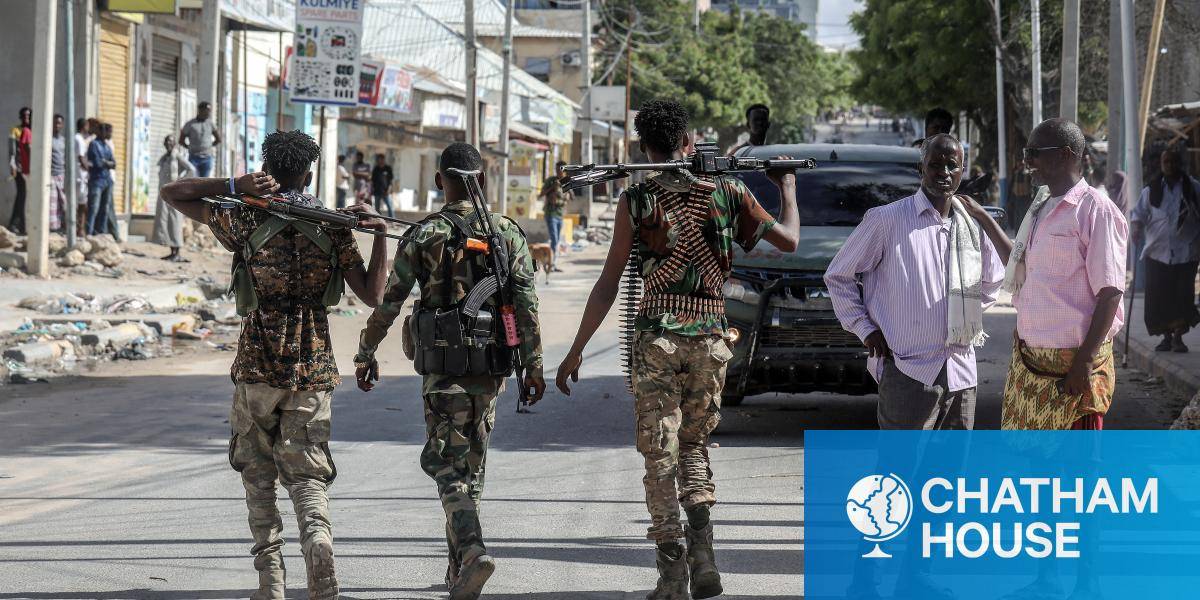 Somali government forces patrol a street in Mogadishu