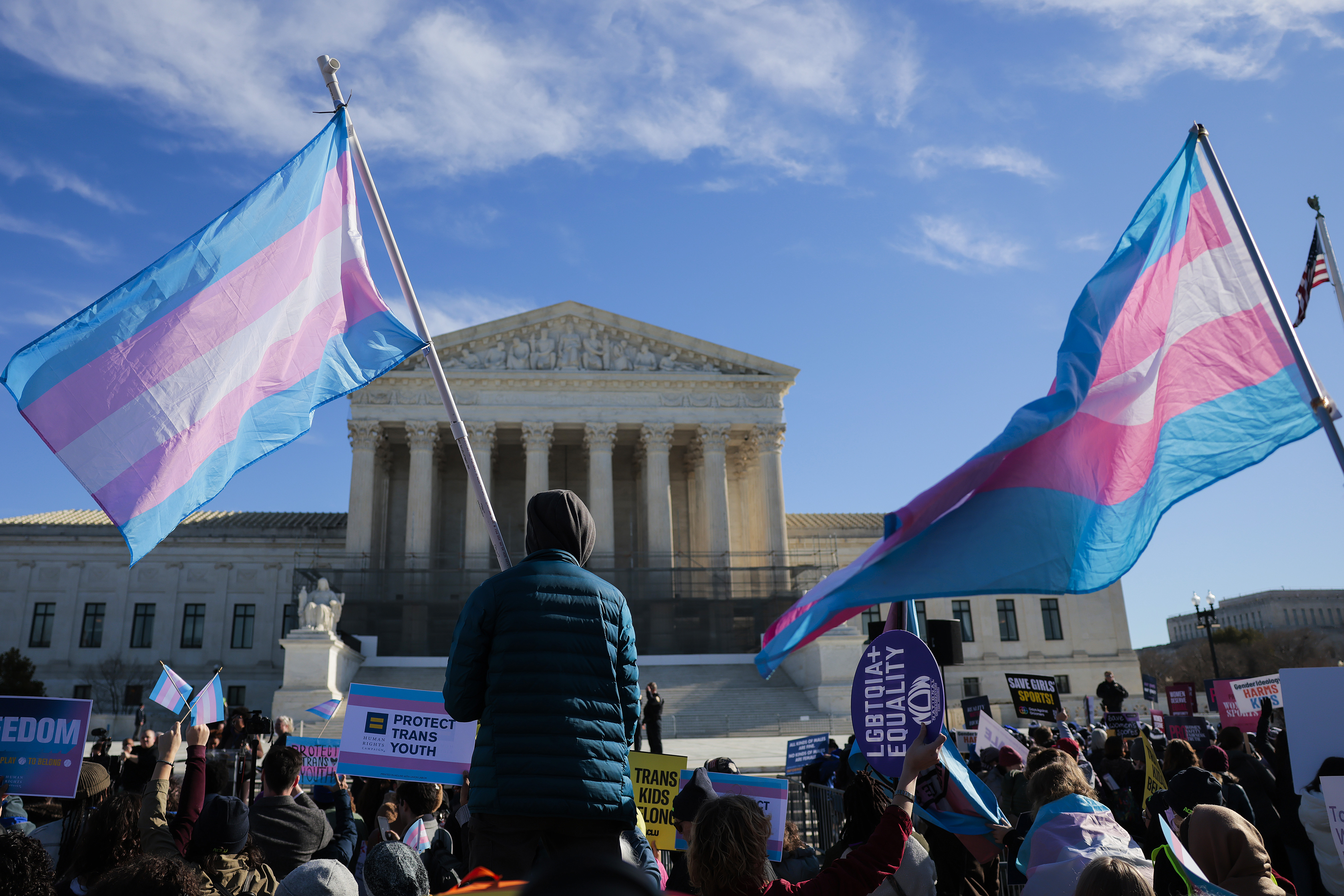 WASHINGTON, DC - JANUARY 13: Protesters supporting transgender athletes competing in women's sports gather outside the Supreme Court on January 13, 2026 in Washington, DC. Groups from both sides of the debate gathered on Tuesday morning to protest while two cases that prohibit transgender girls from joining girls' and women's sports teams are heard inside the Supreme Court. (Photo by Heather Diehl/Getty Images)