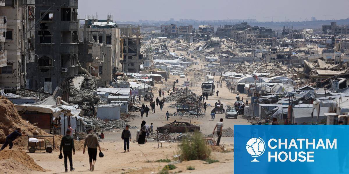 People walk between tents in Gaza