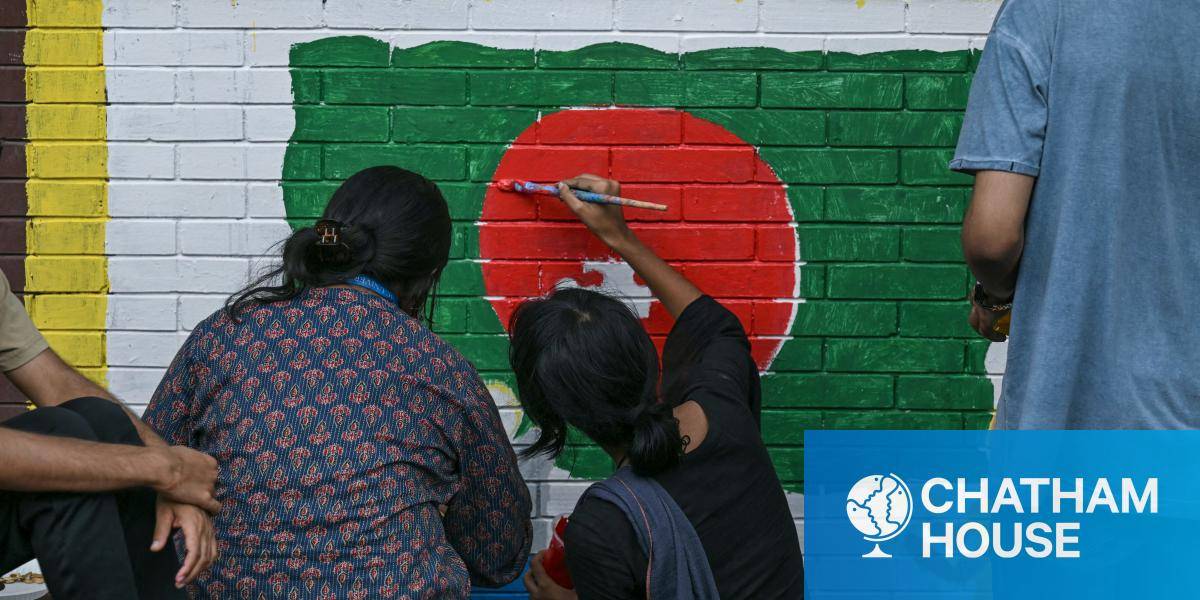Students paint a mural in the colours of the Bangladesh national flag.