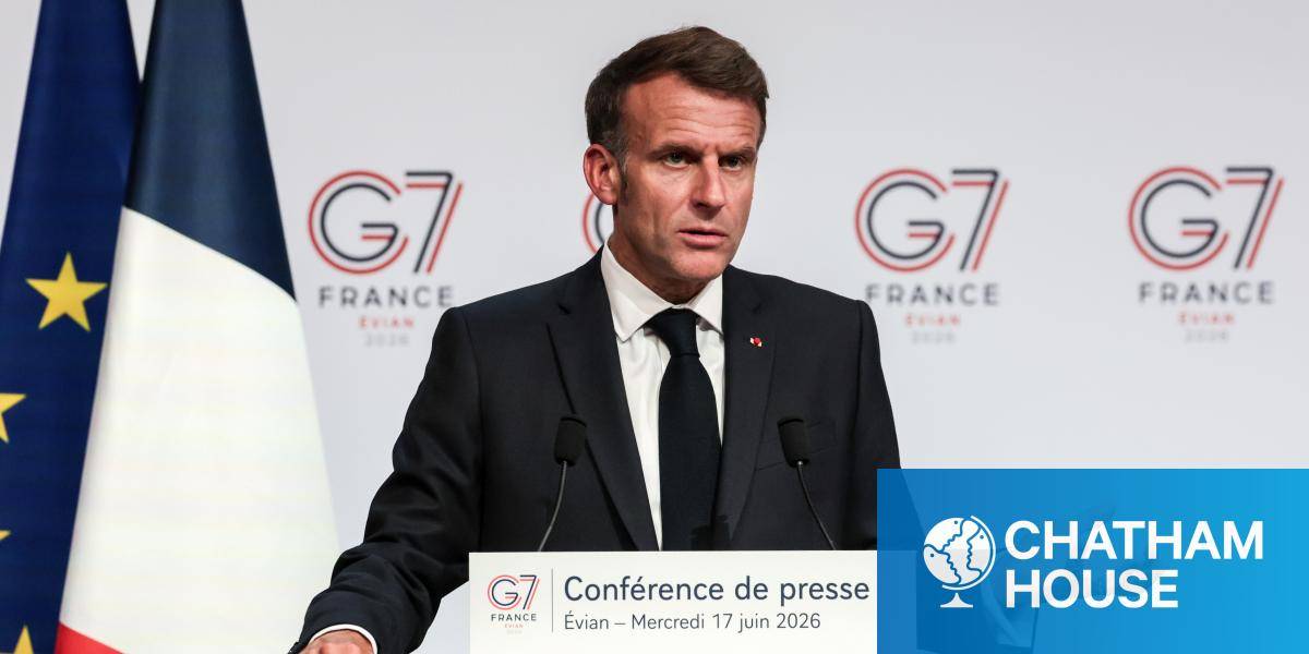 President Macron gestures while speaking at a G7 press conference, with French and EU flags behind him