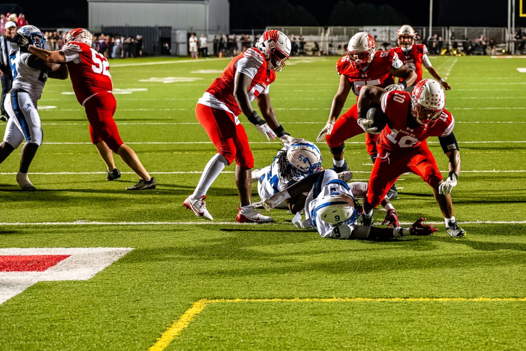 Smyrna senior, Chrystian Carroll, breaks through a Middletown tackle to score.