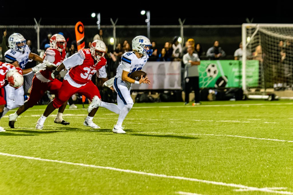 Middletown quarterback, Kyle McCaffery, avoids the Smyrna rush and takes off downfield.