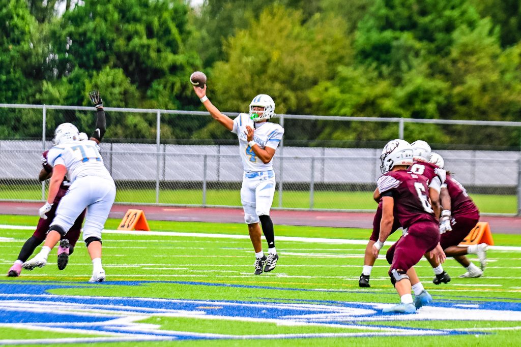 Tingle makes a leaping throw to a receiver down field. Photo Credit: Dave Reeder.