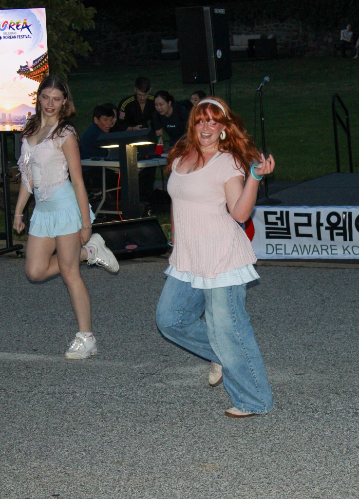 Two people dance a K-pop routine