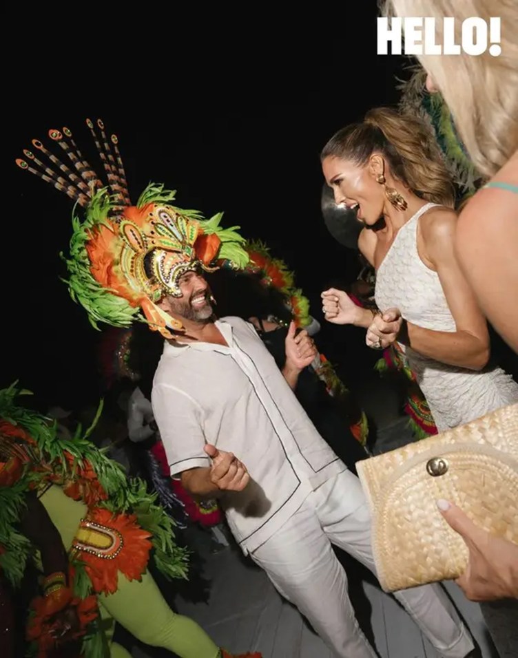 Donald Trump Jr. wears a multicolored Junkanoo headpiece while dancing with Bettina Trump.