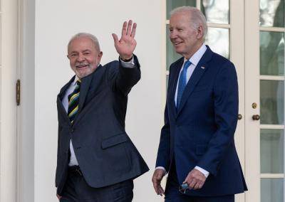 President Lula waves, walking next to President Joe Biden, in 2023