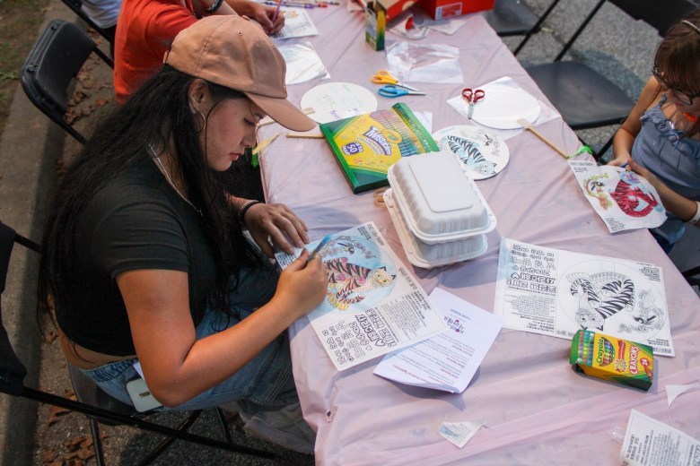 A person at a festival activity table