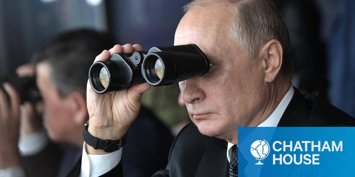 Russian President Vladimir Putin looking through binoculars at strategic military drills 