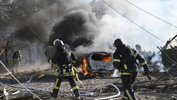 Ukrainian firefighters work at the site of a strike in the city of Kramatorsk.