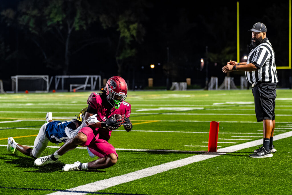 The Hawks receiver completes the catch while falling in the endzone.