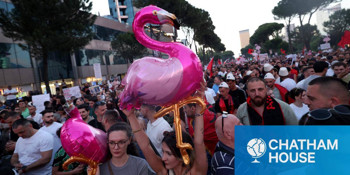 Protestors hold inflatable flamingos as they gather in front of the Albanian Prime Minister's Office in Tirana