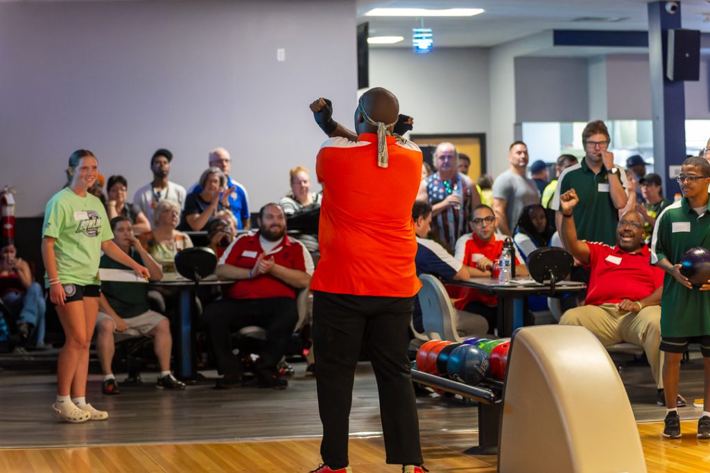 The celebration continues with the crowd as he puts up an X indicating the strike.
