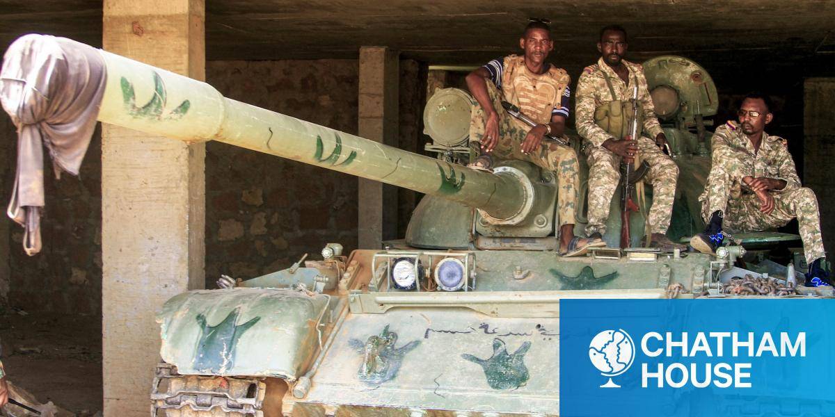 Sudanese army soldiers sit atop a parked tank after their capture of a base used by the Rapid Support Forces, pictured in May 26, 2025.