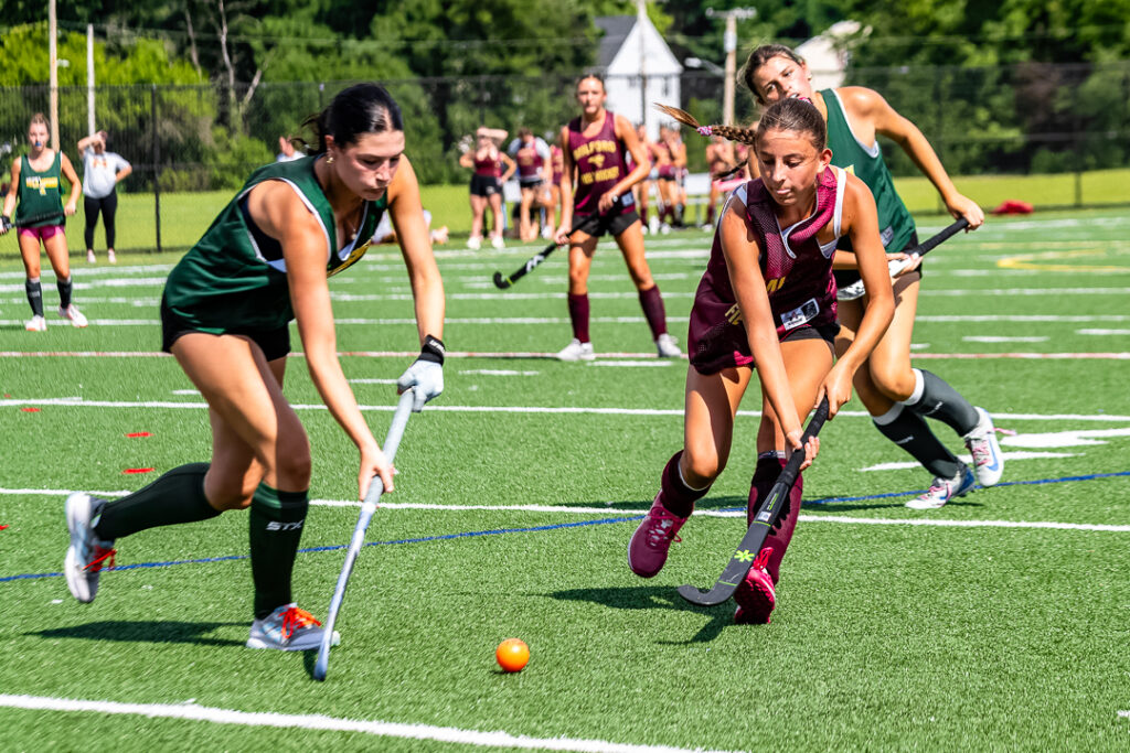 Players from the Spartans and Buccaneers run toward the ball to regain possession. 