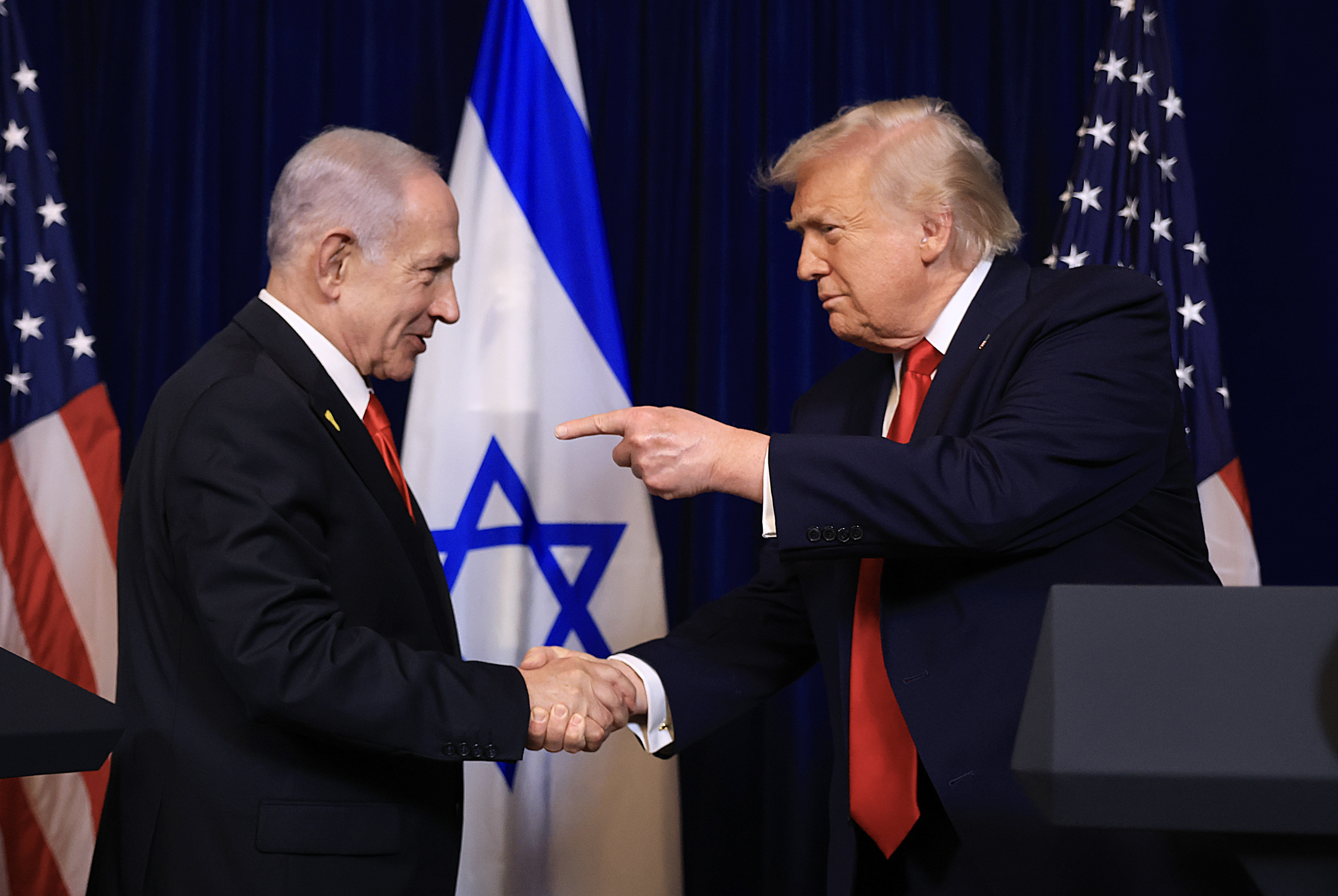 PALM BEACH, FLORIDA - DECEMBER 29: (EDITOR'S NOTE: Alternate crop) U.S. President Donald Trump shakes hands with Israeli Prime Minister Benjamin Netanyahu during a press conference at his Mar-a-Lago club on December 29, 2025 in Palm Beach, Florida. The two leaders held a bilateral meeting to discuss regional security in the Middle East as well as the U.S.-Israel partnership.  (Photo by Joe Raedle/Getty Images)