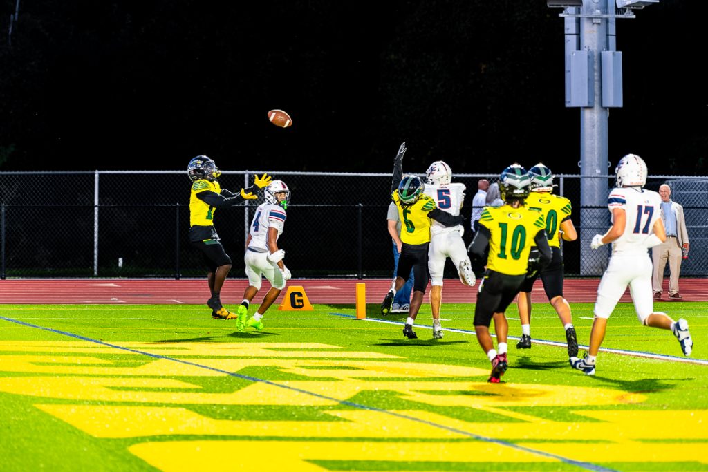 Odessa senior Thomas Ngateh leaps into the air and focuses on catching the ball for an interception.
