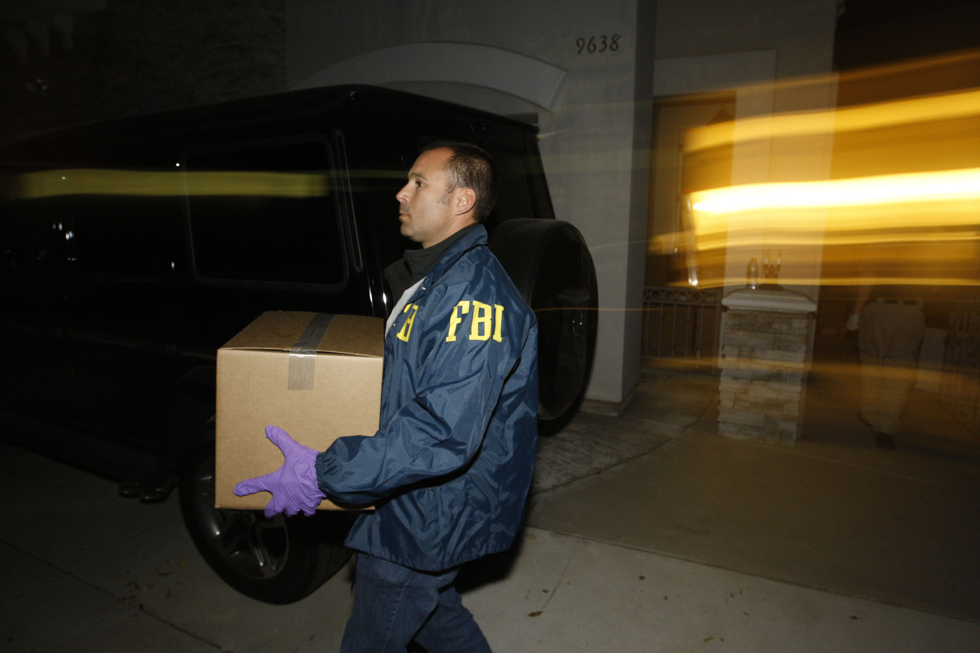 FBI agents remove evidence from a private home at 9638 Naomi in Arcadia on March 8, 2012. Federal officials on Thursday announced fraud charges against a man accused of selling $1.3 million in counterfeit wines. The U.S. attorney's office in New York alleges that wine dealer Rudy Kurniawan claimed he was selling rare vintage French wine at various audctions. He was arrested in Los Angeles by the FBI.  (Photo by Gary Friedman/Los Angeles Times via Getty Images)