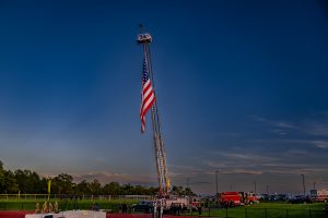 The Odessa Fire Company displays a large American flag from one of its engines as Odessa celebrated Military Appreciation Night.